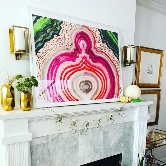 a pink chic wall art above a fireplace